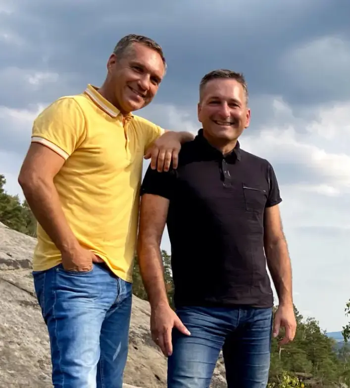 Zwei Männer auf Felsen mit Landschaft im Hintergrund